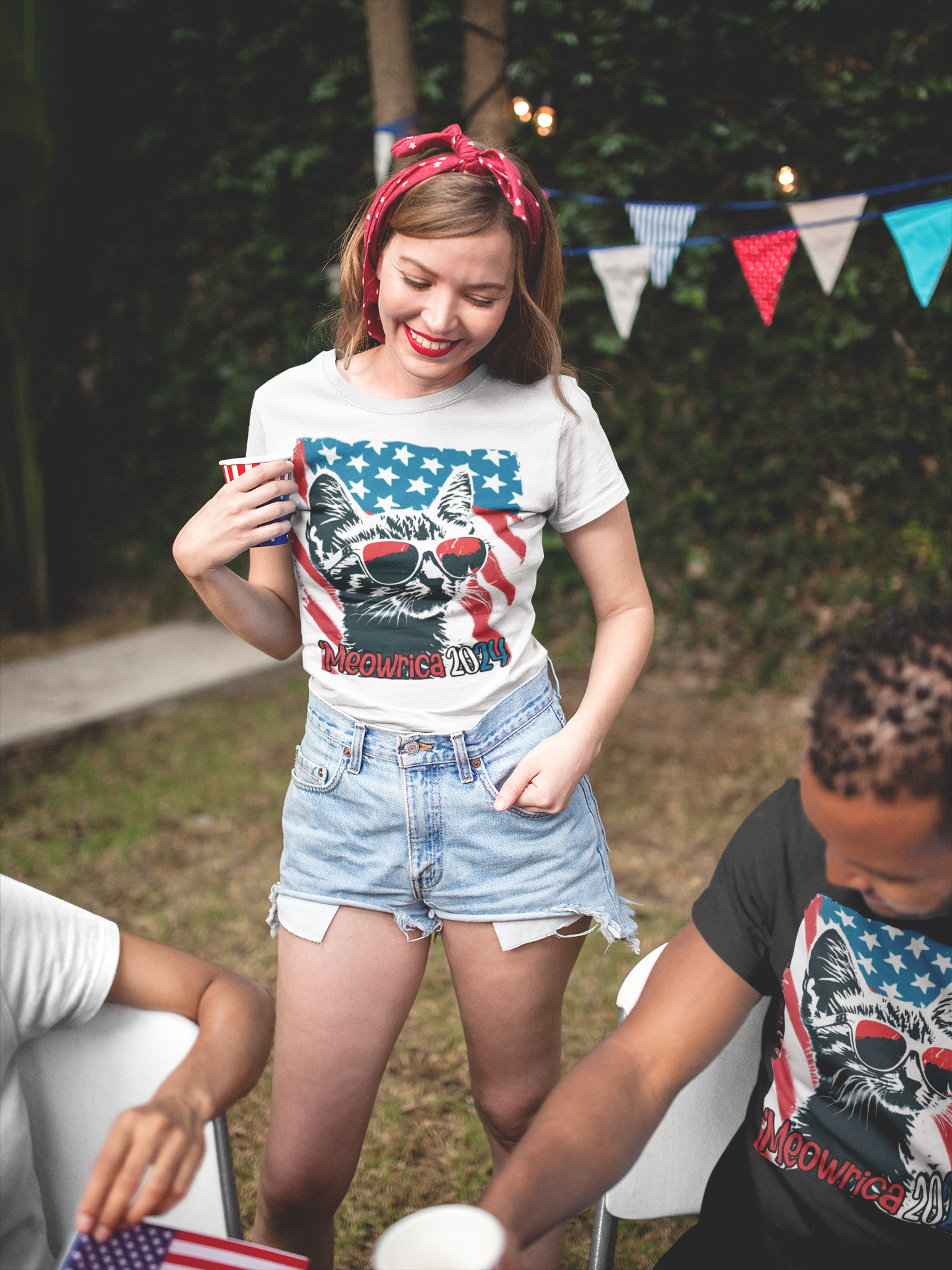 Woman wearing shirt with image of cat and flag text Meowrica 2024