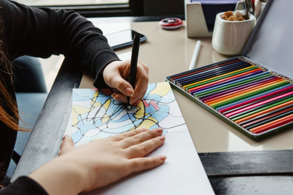 Close up of hands of woman coloring