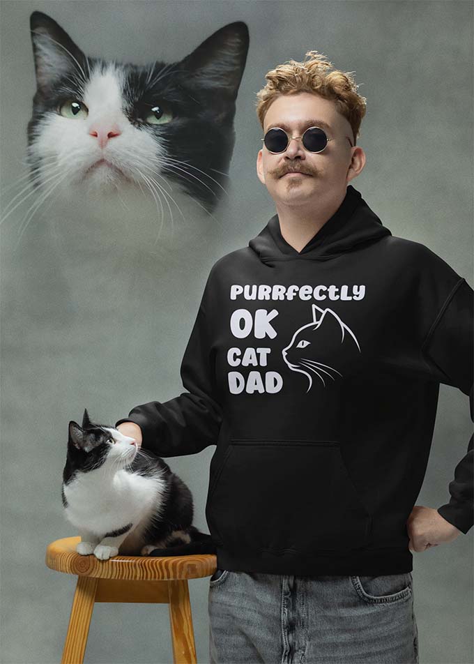 Man with cat wearing hoodie with text Purrfectly OK Cat Dad